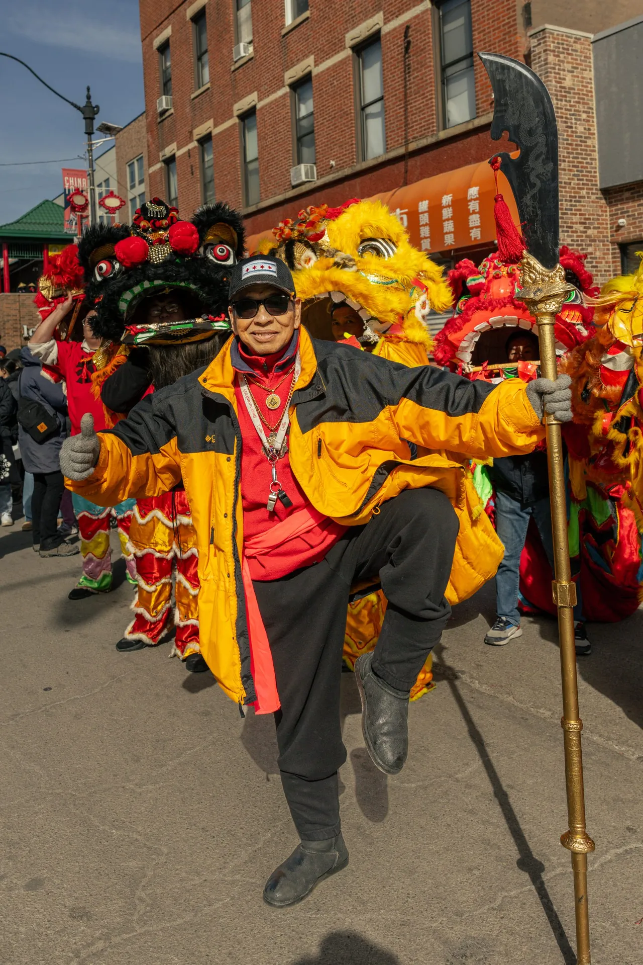 A lion dancer in red and gold on the street