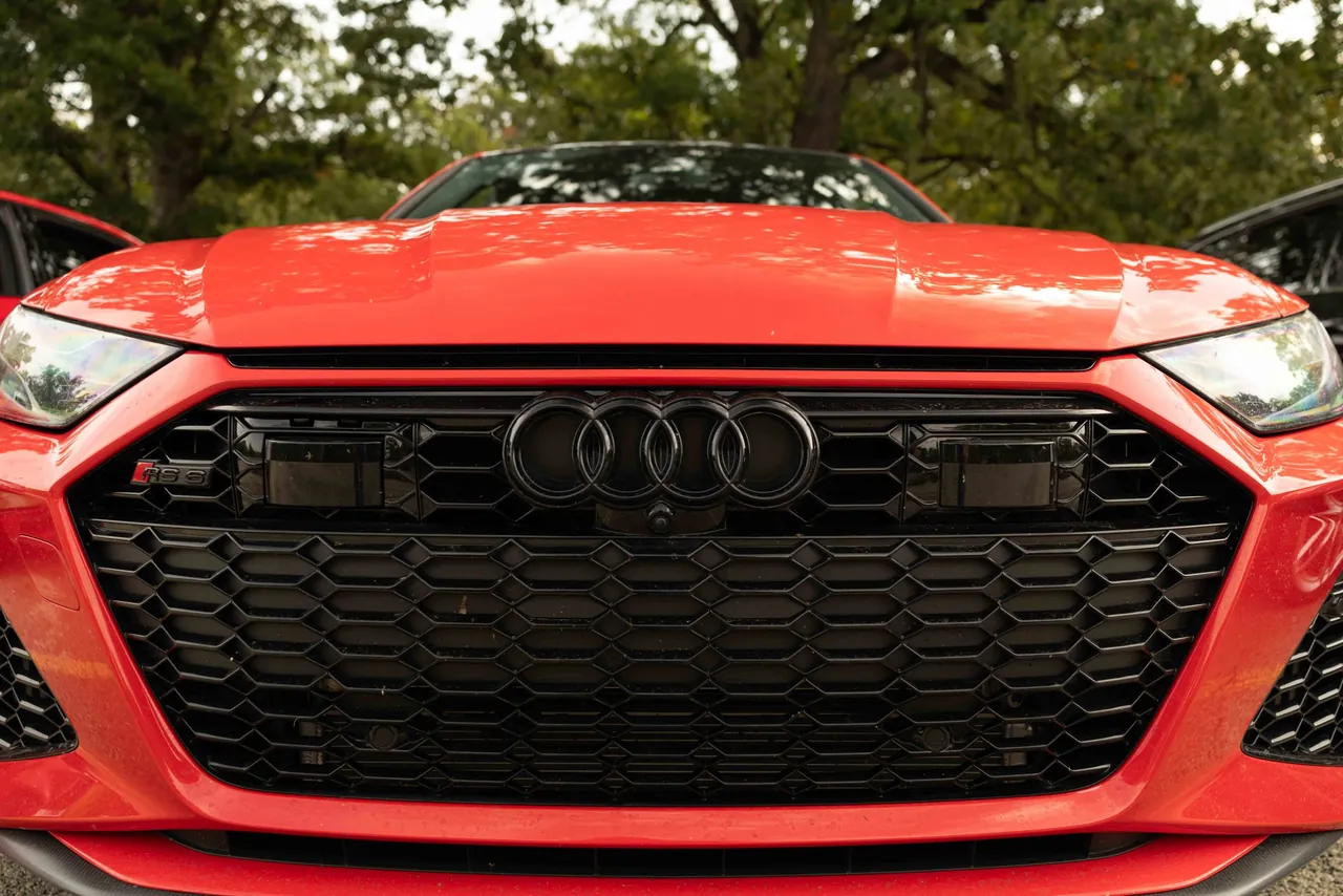 The front grille of a red Audi
