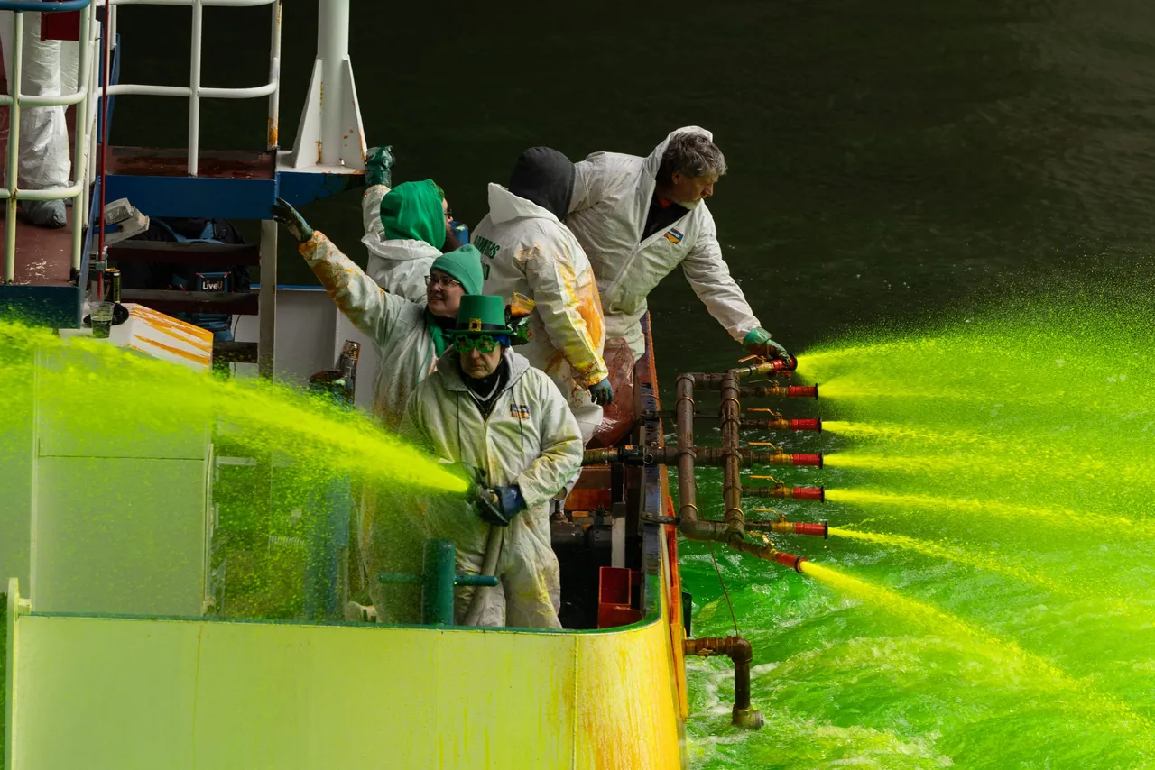 Workers on a boat spray green dye into the Chicago River