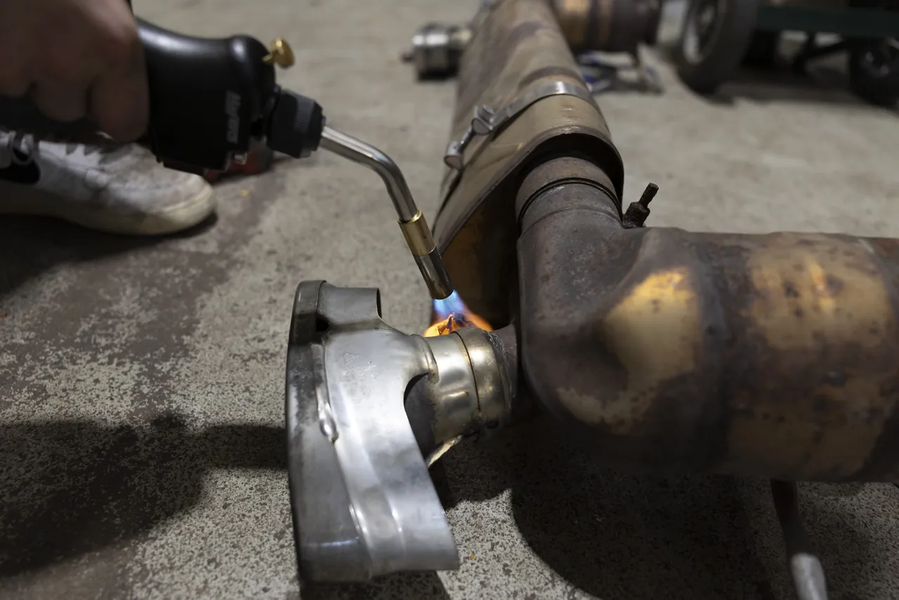 A torch heats an exhaust joint