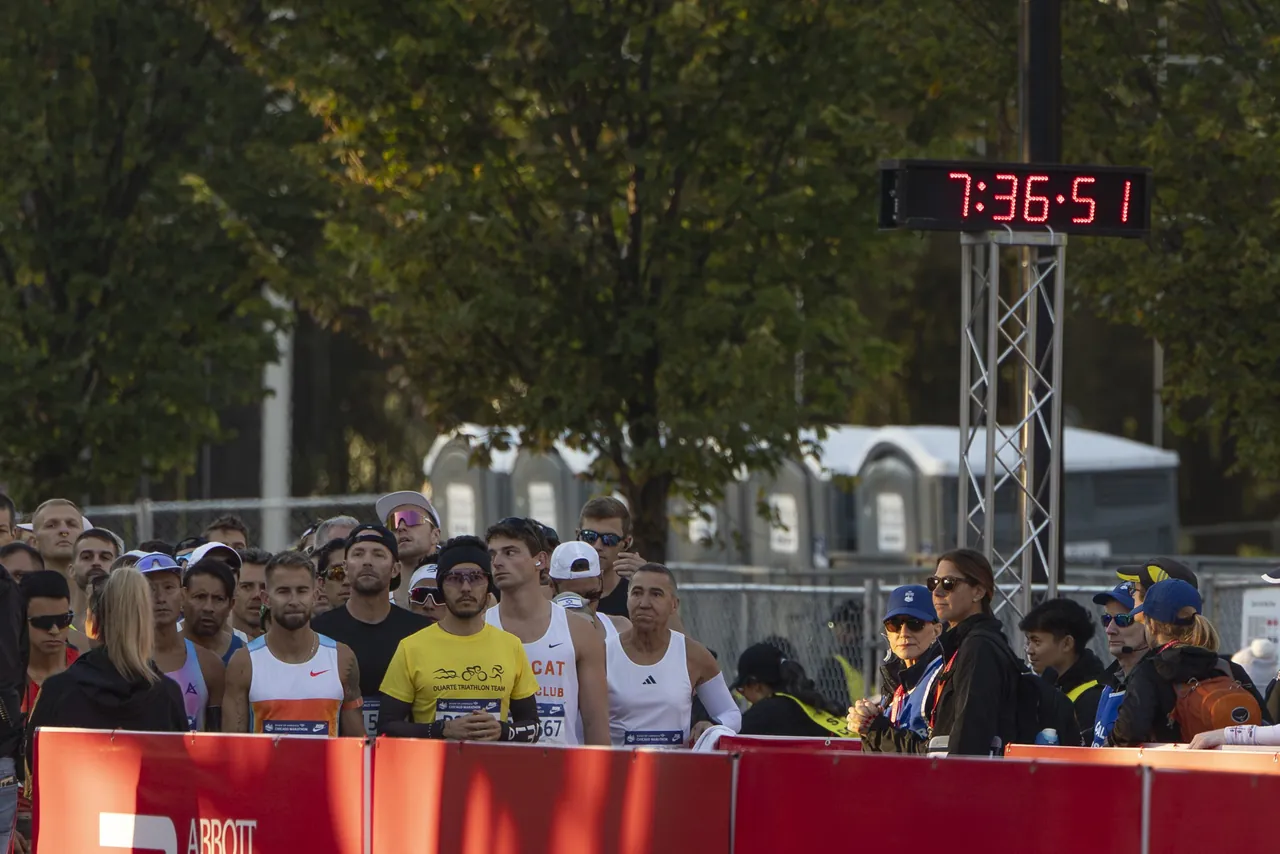 Runners packed at the start line under the race clock