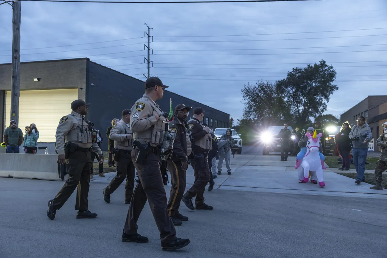State troopers walk in a line down the street at dusk