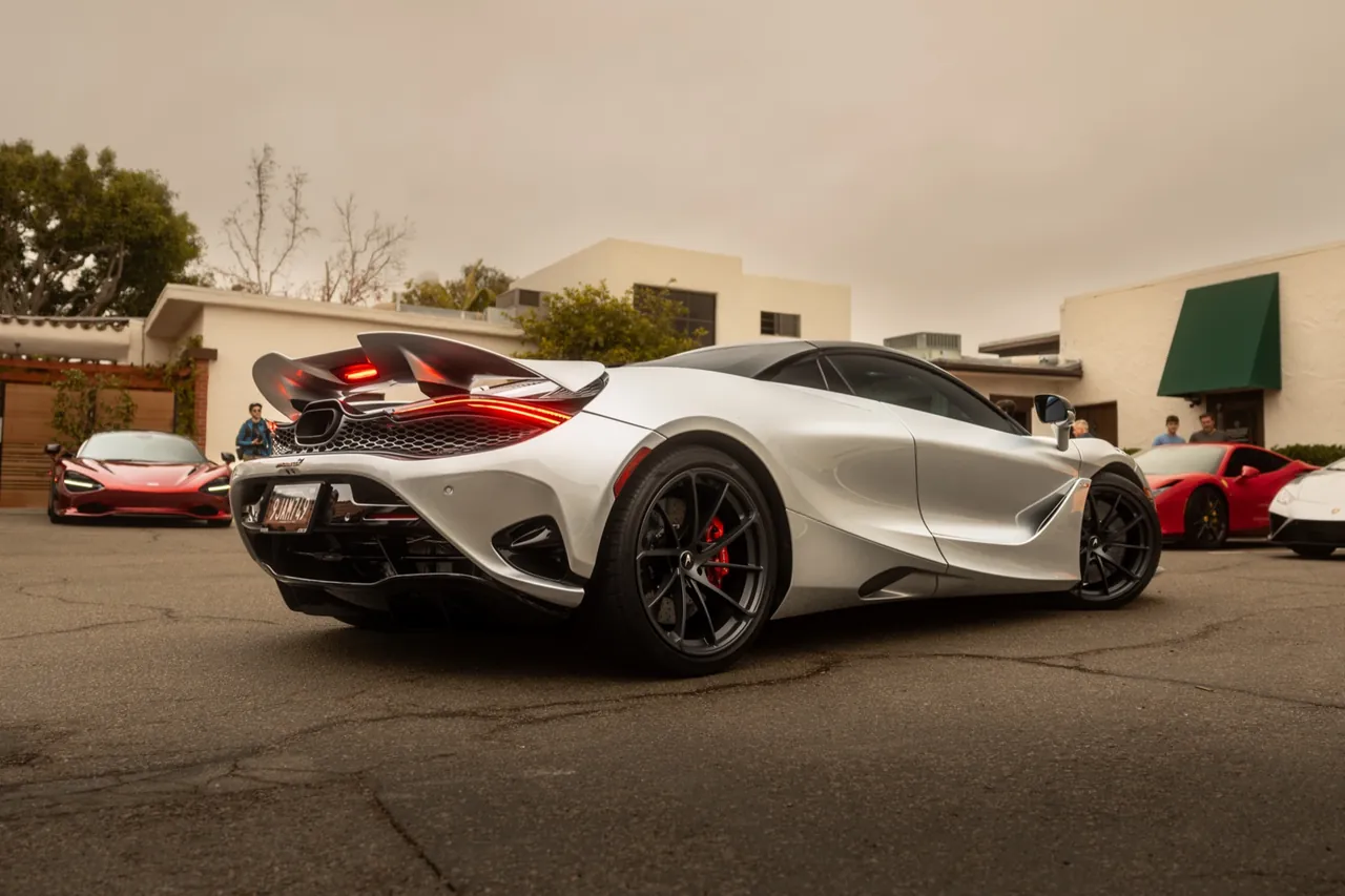 A white McLaren parked at golden hour