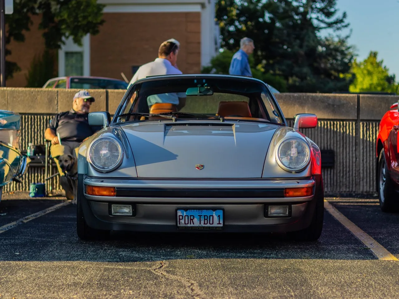 A silver Porsche 911 from the front bumper
