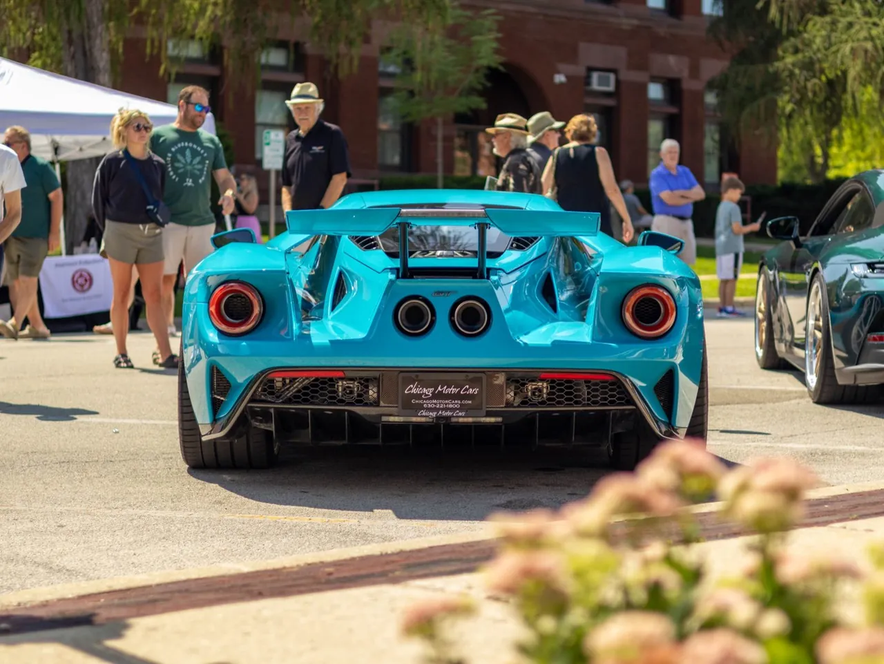 A turquoise Ford GT from behind in a crowd