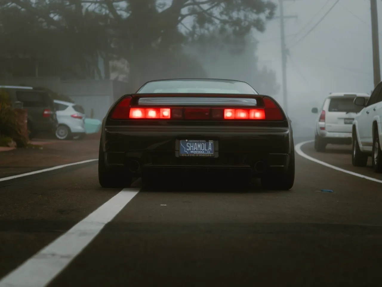 An NSX from behind in the fog