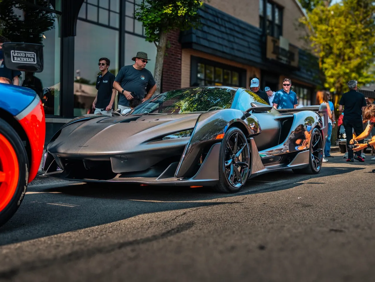A gray hypercar at a car meet